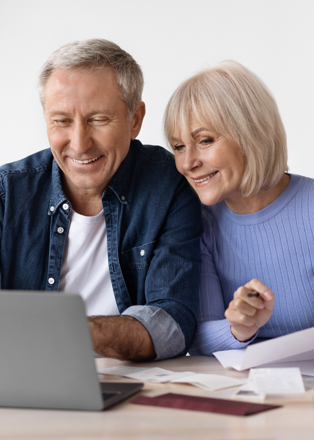 Smiling couple using laptop together