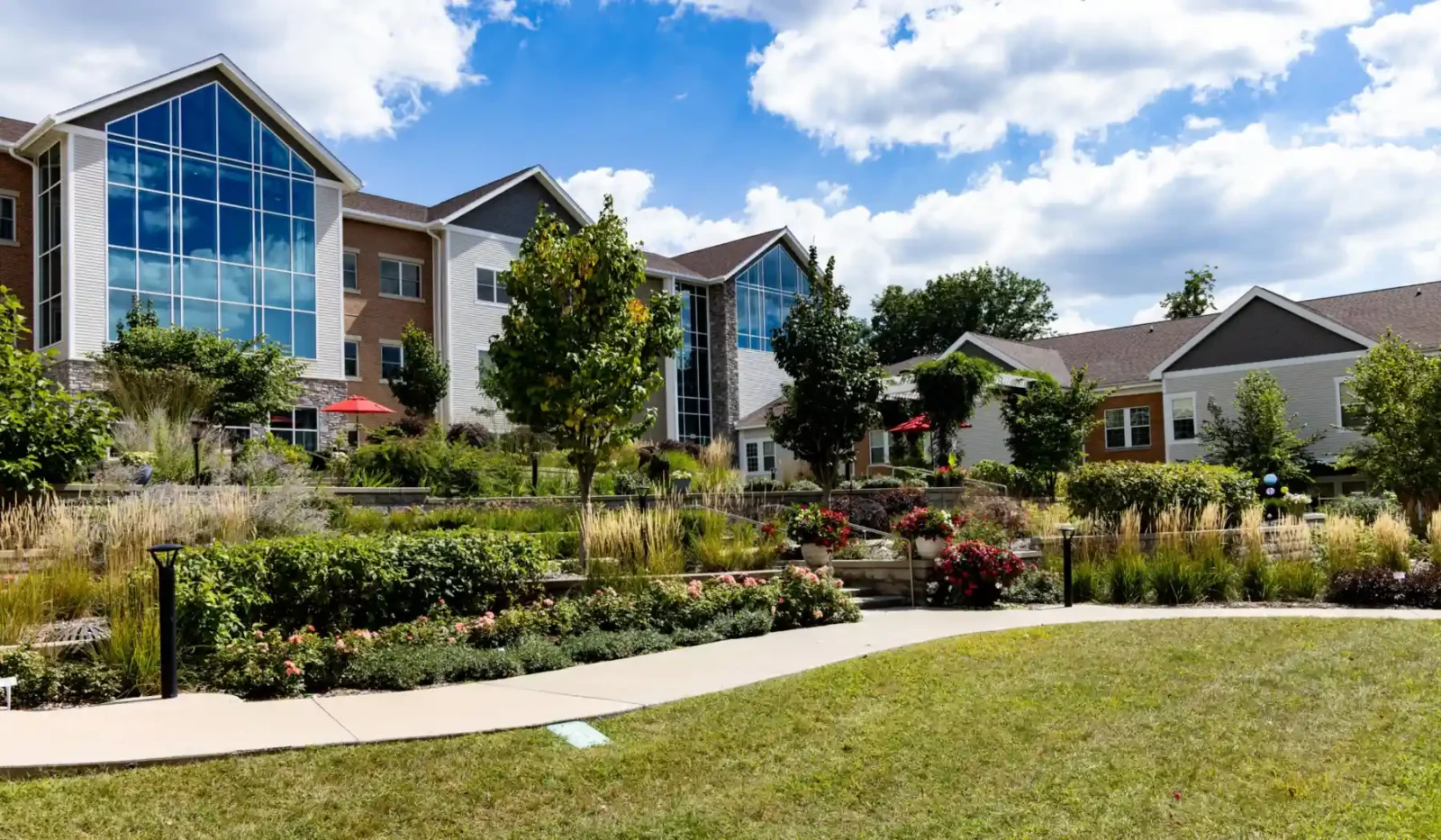 Exterior view of Cottage Grove Place senior living community with landscaped grounds