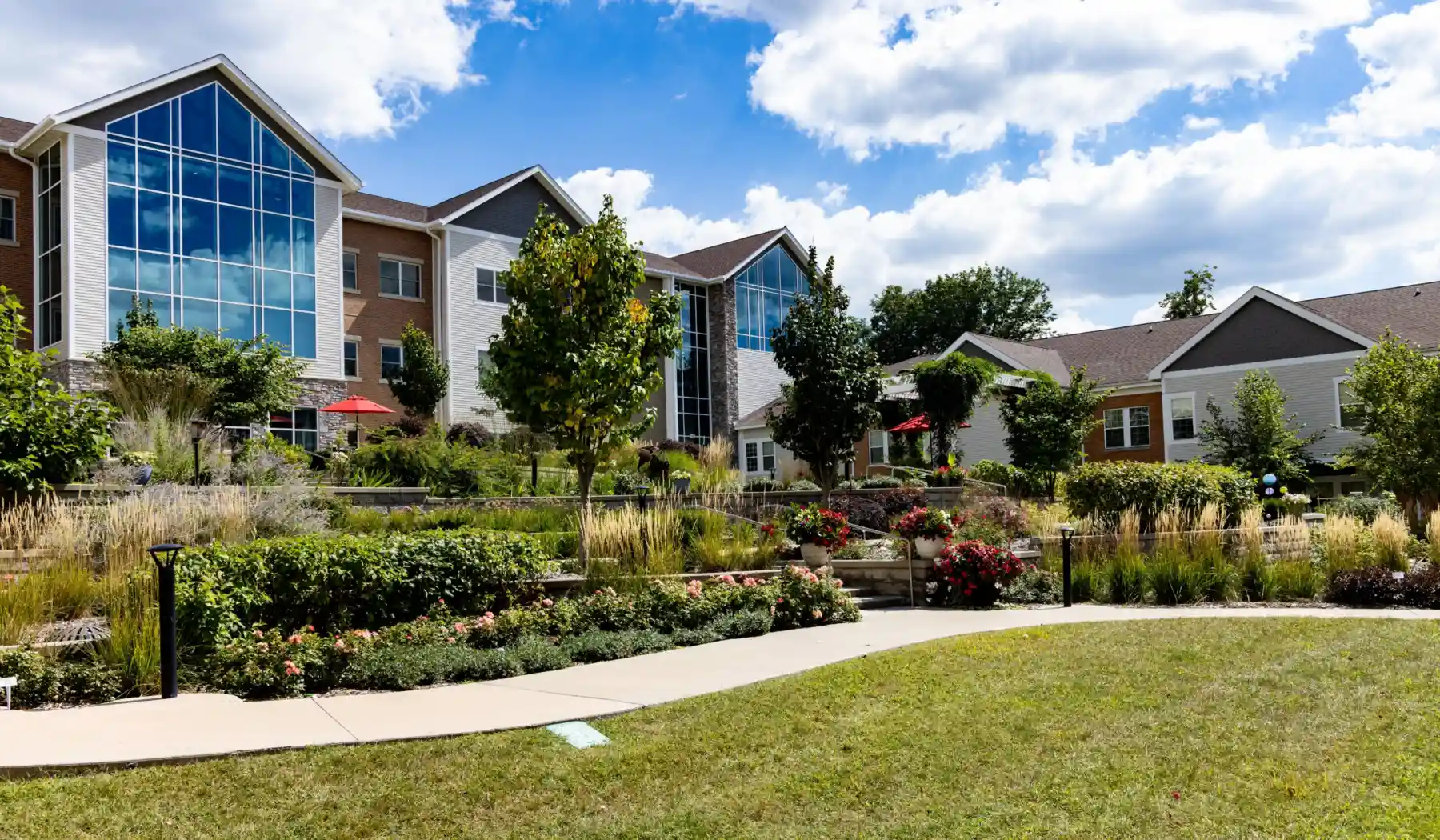 Exterior view of Cottage Grove Place senior living community with landscaped grounds