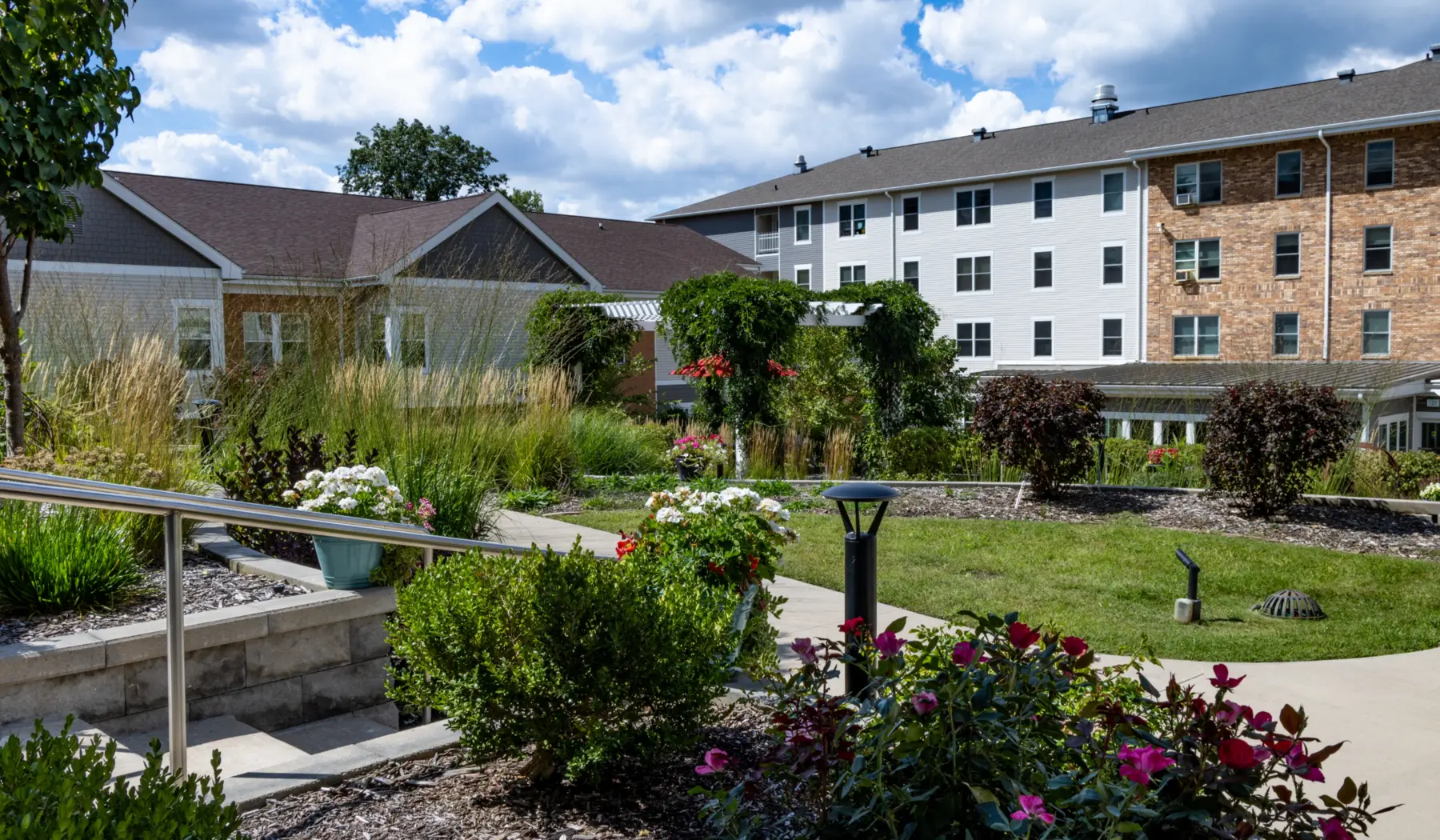 Exterior view of Cottage Grove Place senior living community with landscaped grounds