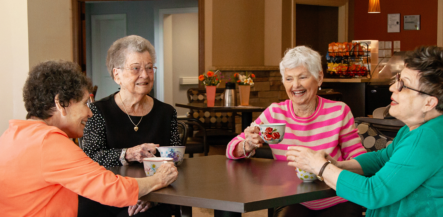 Residents sharing a joyful moment at Cottage Grove Place senior community