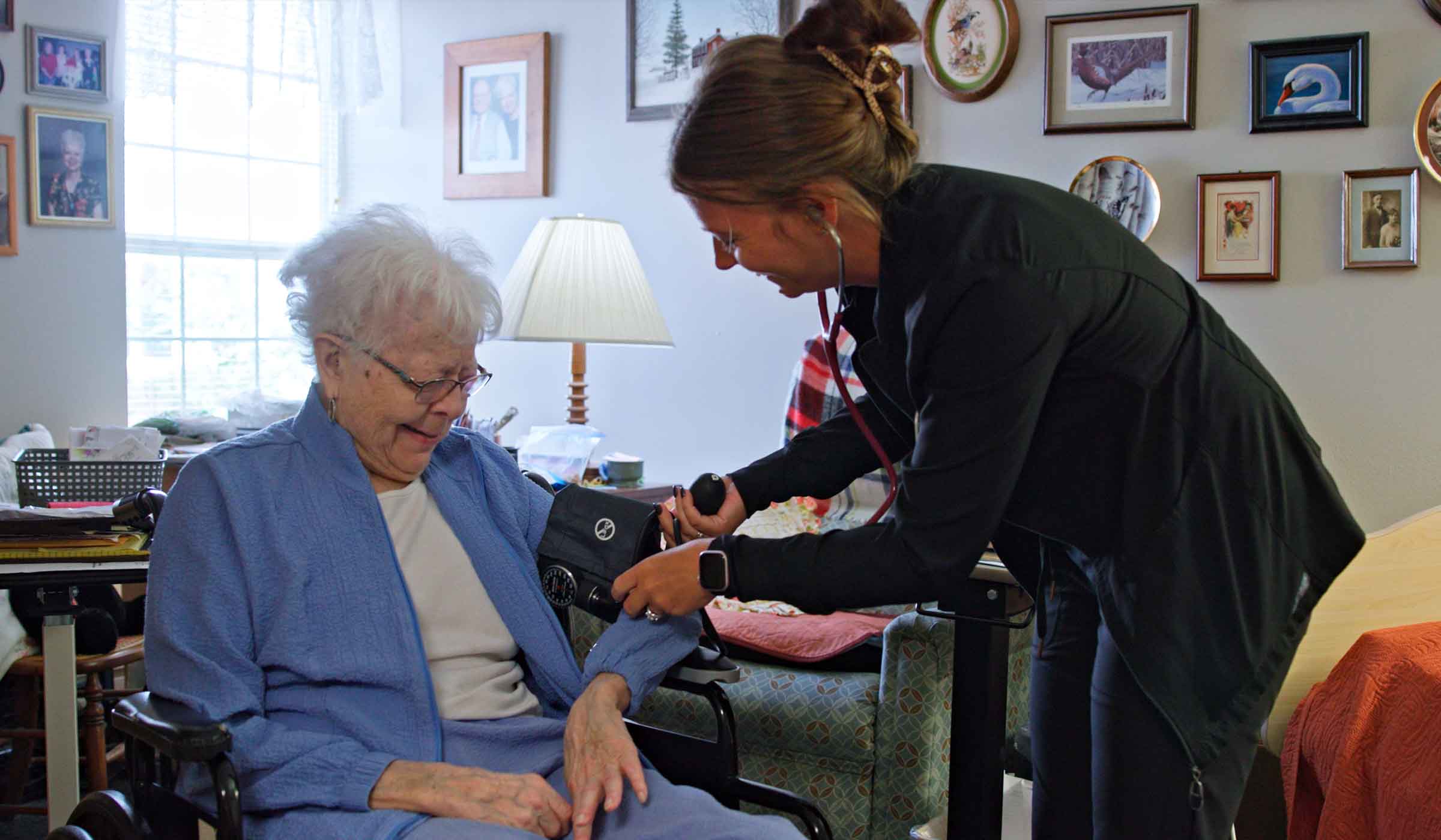 Nurse providing assisted living support to a resident at Cottage Grove Place senior community