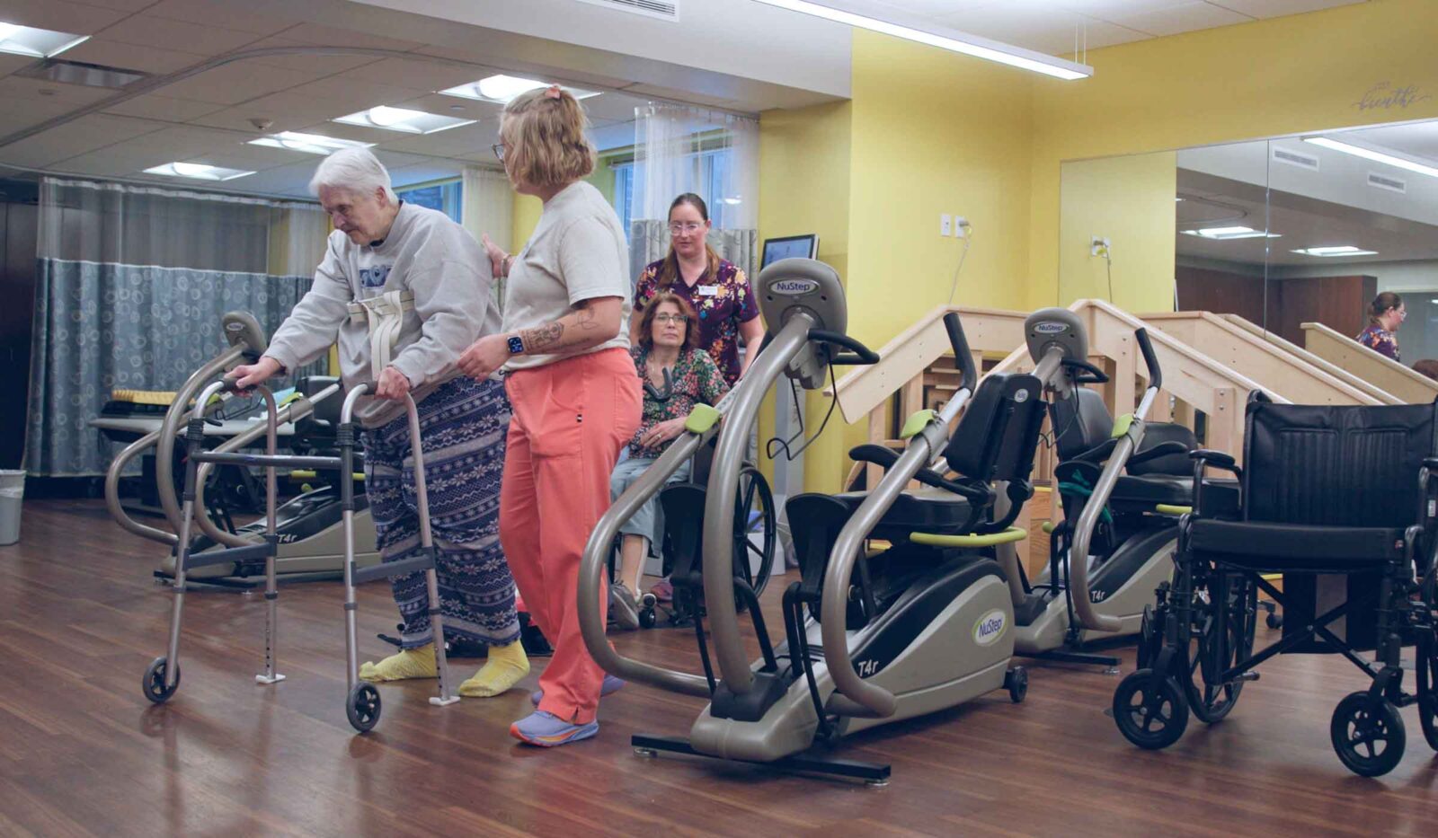 Resident working with therapy staff in the exercise room at Cottage Grove Place senior living community