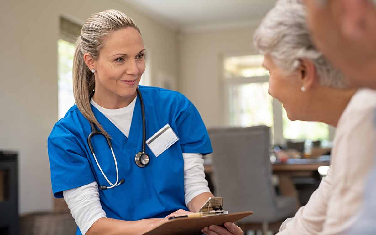 Caregiver assisting a senior with daily health needs at Cottage Grove Place