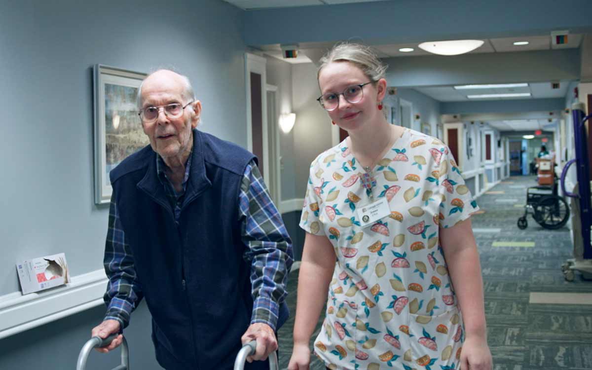 Resident receiving attentive nursing care from staff at Cottage Grove Place
