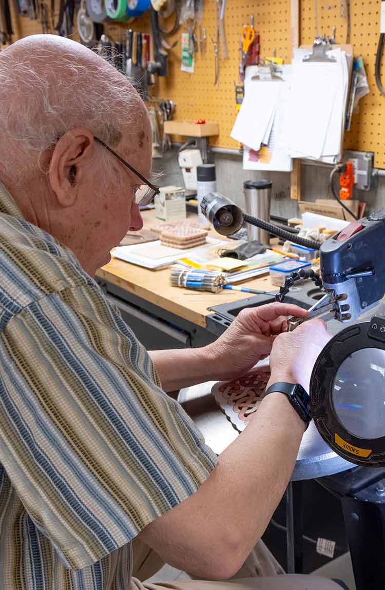 Resident working on a woodworking project at Cottage Grove Place senior living community