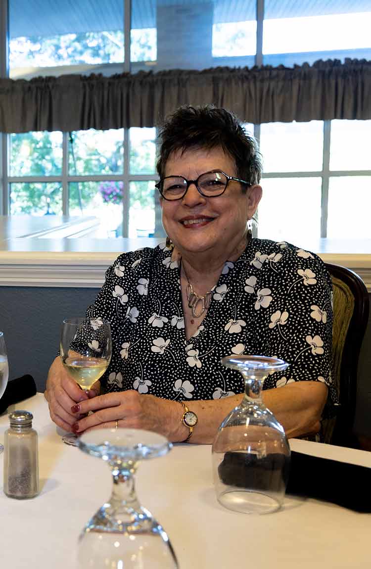 Resident enjoying time at the table at Cottage Grove Place senior living community