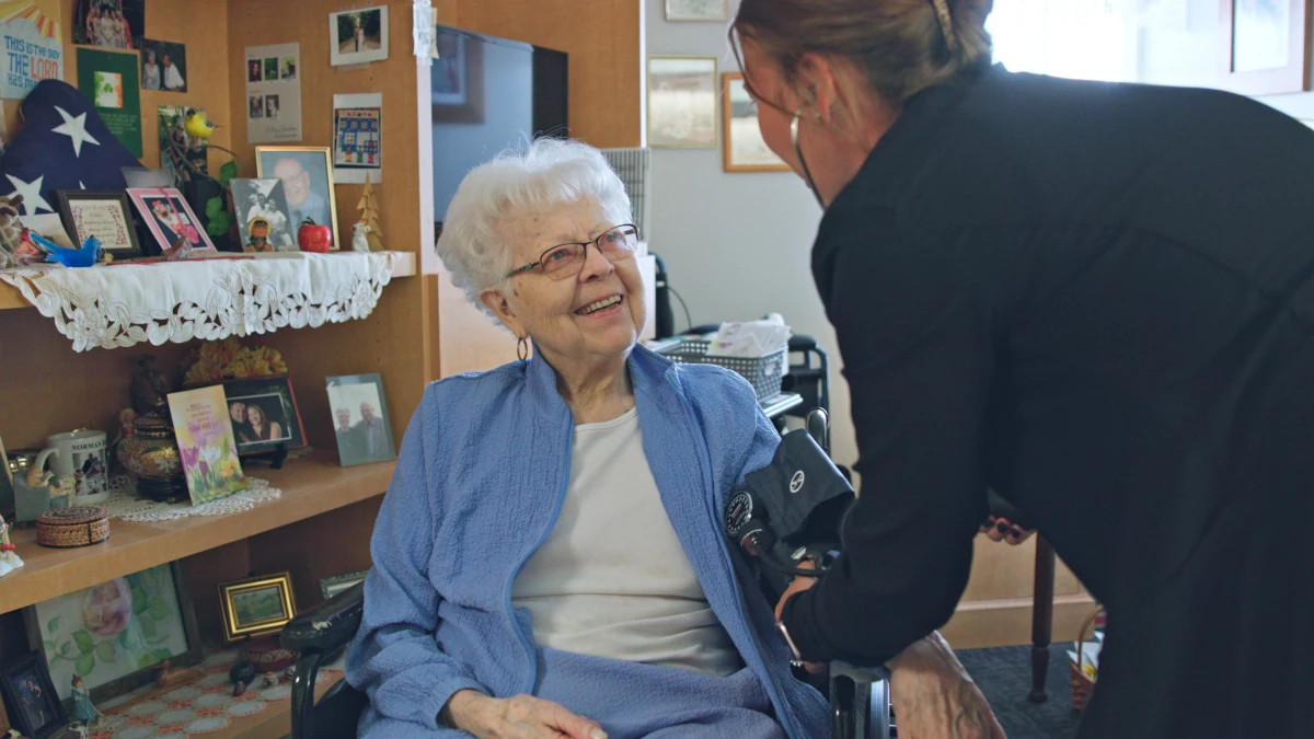 A Cottage Grove Place resident receiving Assisted Living services from a trained nurse.